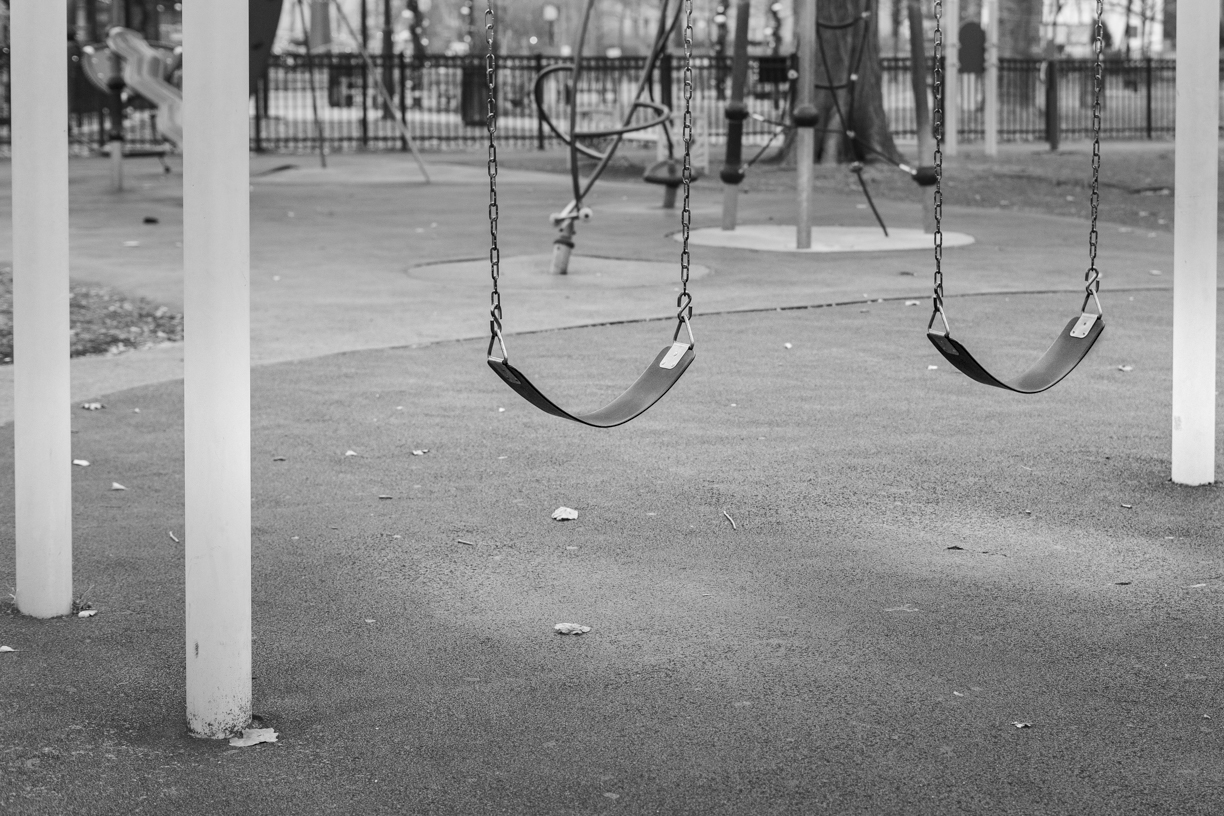 Empty swings in unused playground