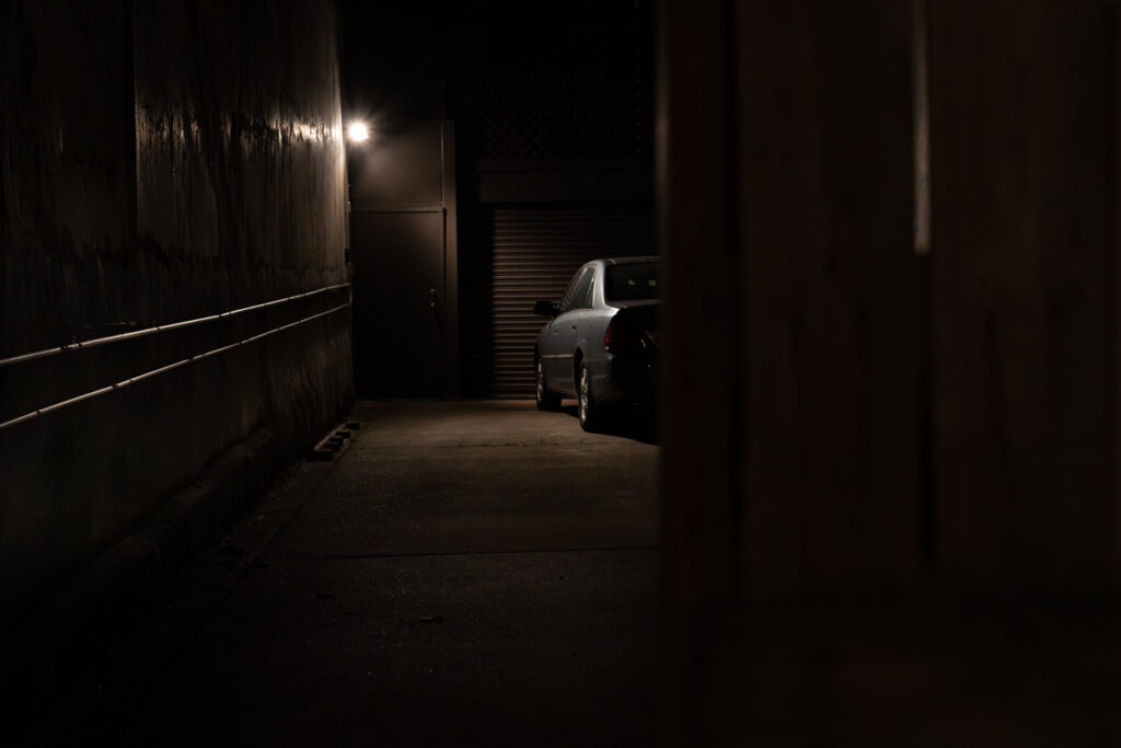 Night color image of car parked in carport.